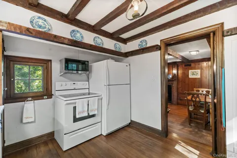 a white refrigerator freezer and a stove sitting inside of a kitchen