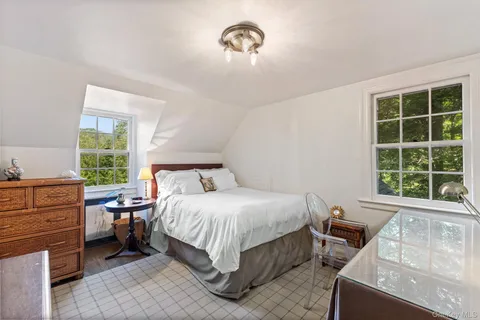 a bedroom with a bed and window