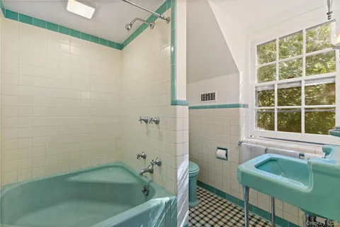 a bathroom with a sink a toilet and a bathtub
