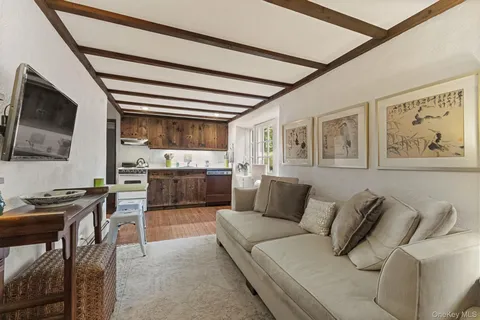 a living room with furniture a window and a flat screen tv