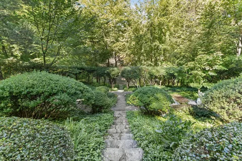 a front view of a house with a garden