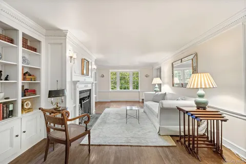 a living room with furniture fireplace and a window