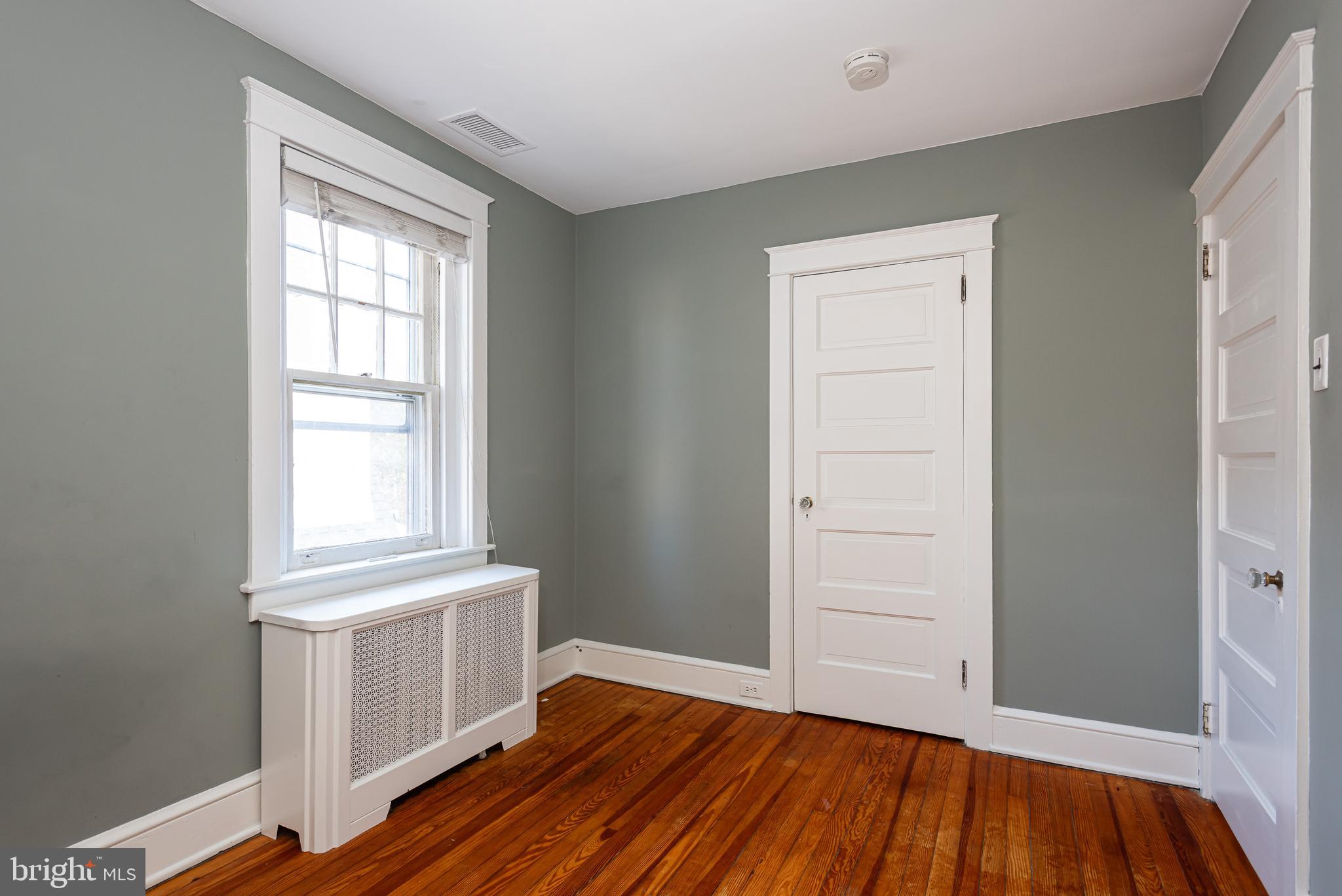 112 Conestoga Road Wayne, PA 19087 - Photo 19 of 32 an empty room with wooden floor and windows