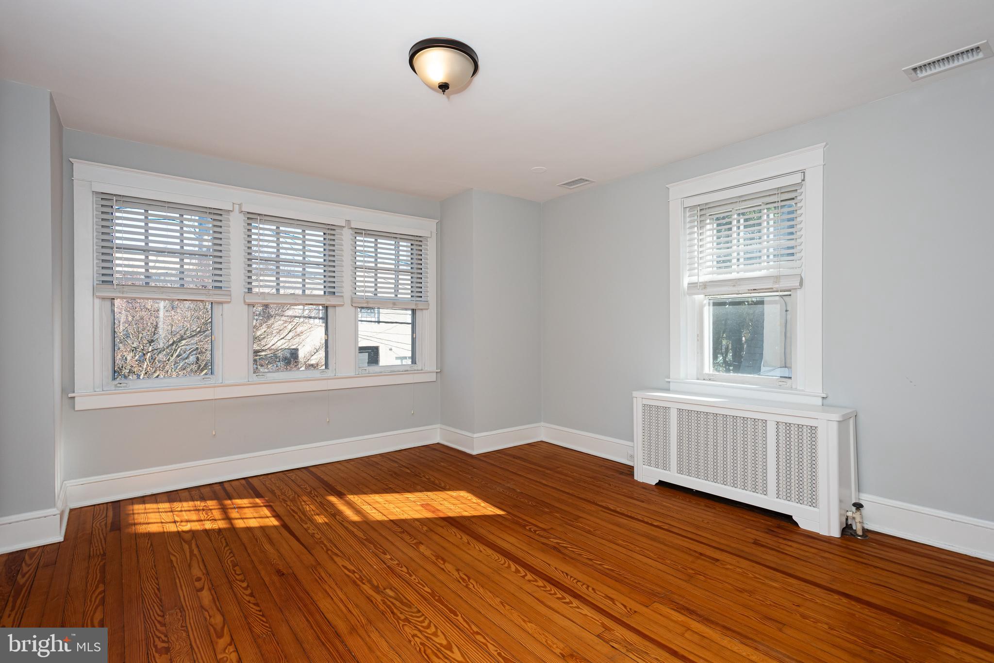 112 Conestoga Road Wayne, PA 19087 - Photo 20 of 32 an empty room with wooden floor and windows