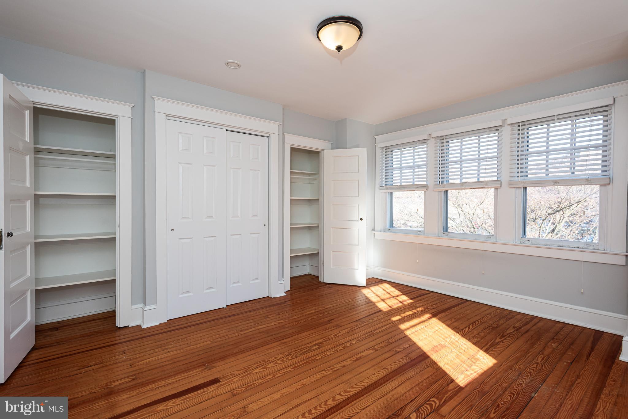 112 Conestoga Road Wayne, PA 19087 - Photo 22 of 32 a view of an empty room with wooden floor and a window