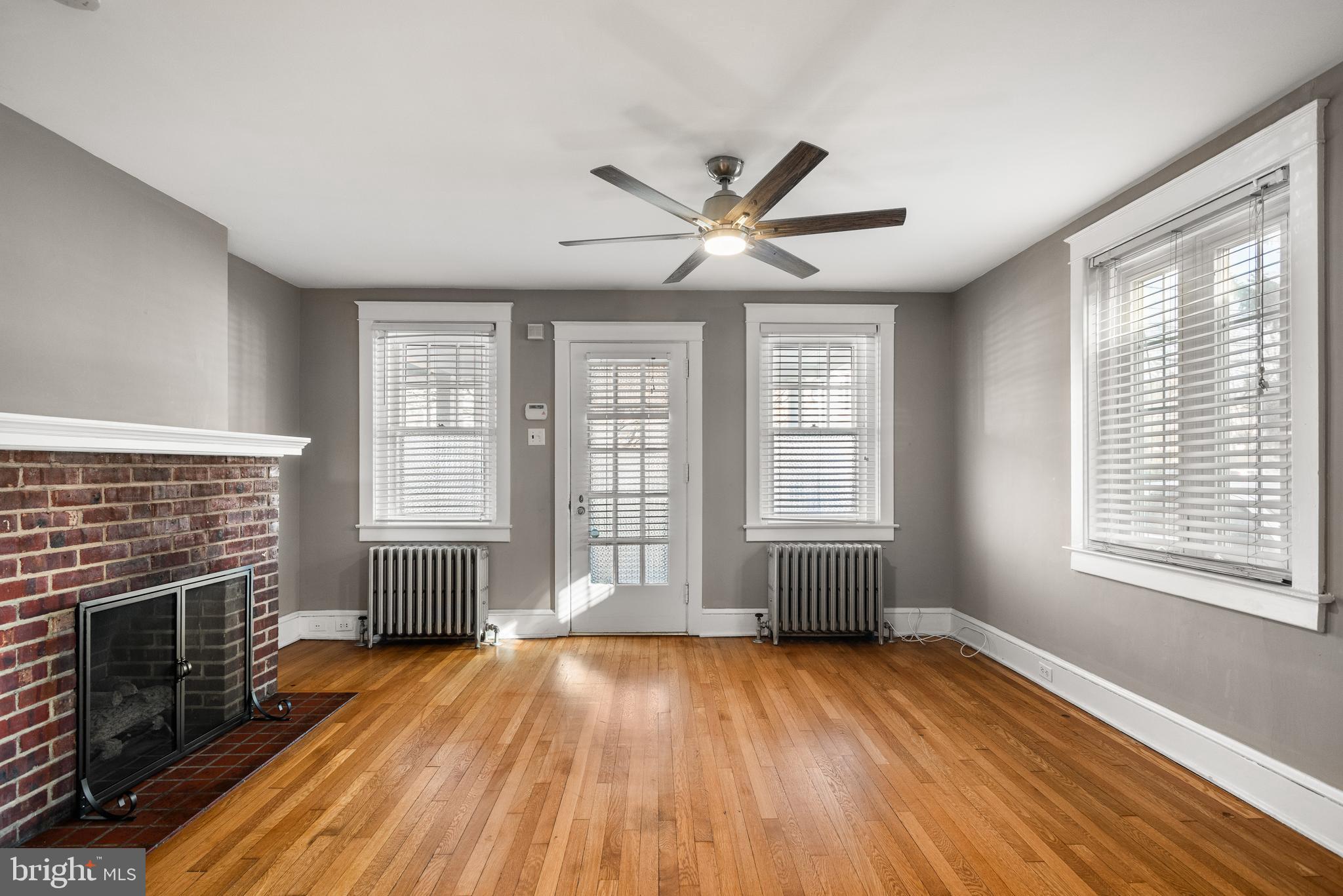 112 Conestoga Road Wayne, PA 19087 - Photo 4 of 32 a view of an empty room with wooden floor and a window