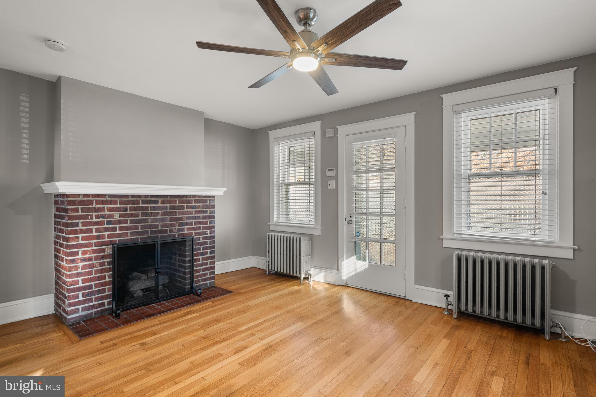 112 Conestoga Road Wayne, PA 19087 - Photo 5 of 32 wooden floor fireplace and windows in an empty room