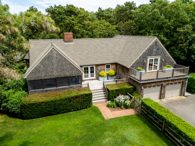 a aerial view of a house with swimming pool next to a big yard