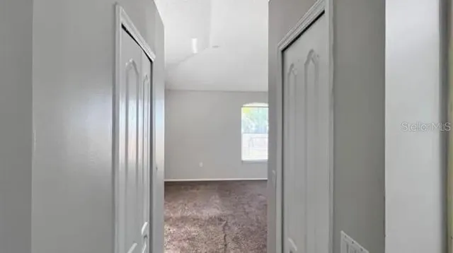 a view of a back yard from a corridor