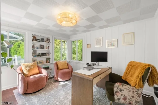 a workspace with furniture and a large window