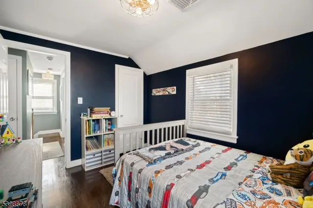a bedroom with a bed and a book shelf