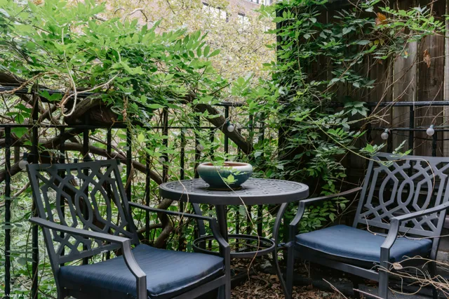 a view of a chairs and table in a balcony