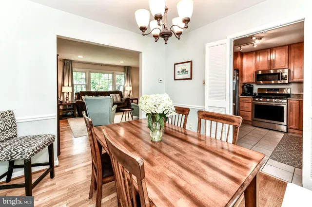 a view of a dining room with furniture a chandelier and wooden floor