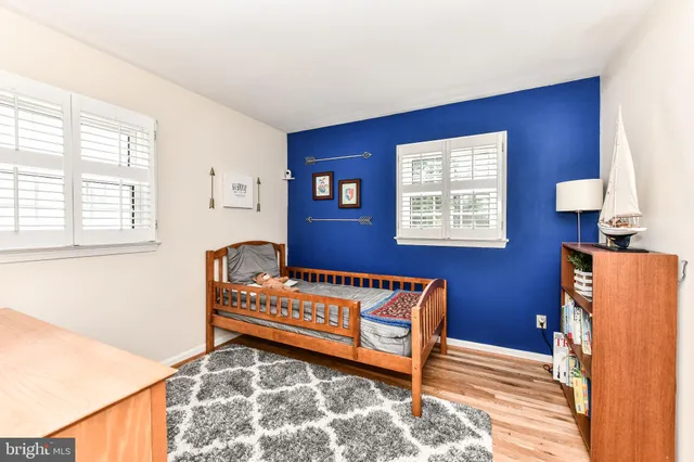 a view of a bedroom with furniture and window