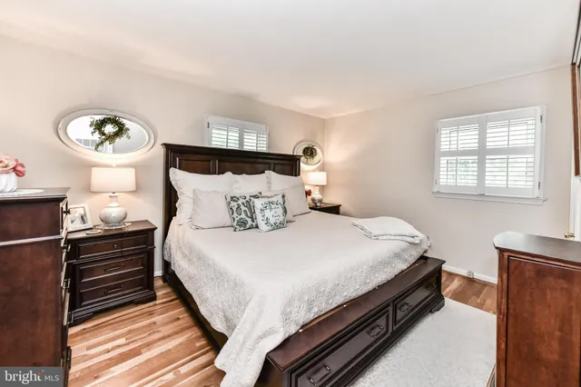 a bed sitting in a bedroom next to a window