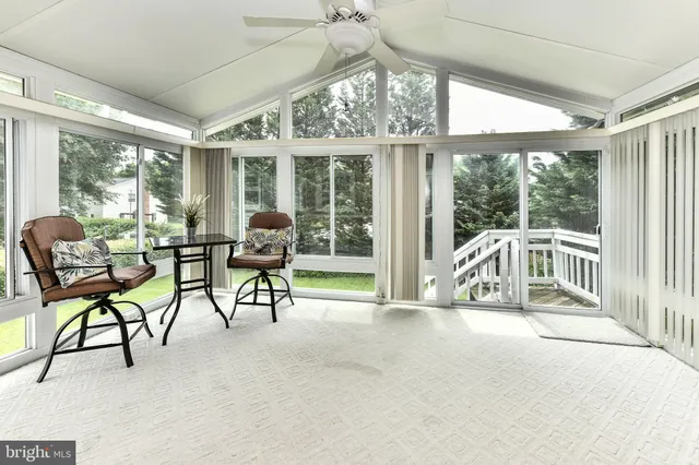 a balcony with furniture and a large window