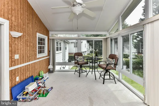 a dining room with furniture a chandelier and a rug