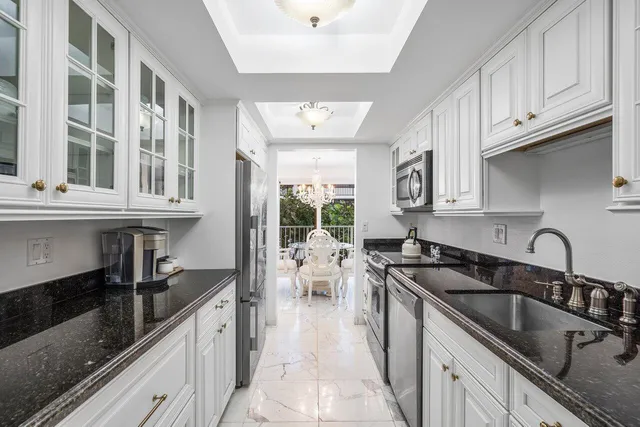 a kitchen with a sink cabinets and window