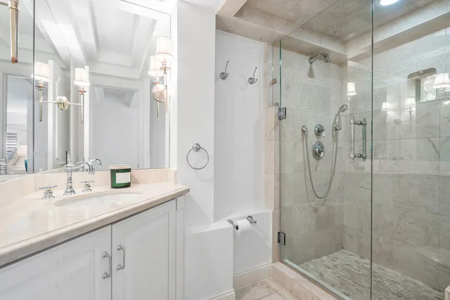 a spacious bathroom with a granite countertop sink a mirror and a