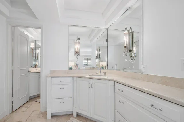 a bedroom with a bed a couch and a flat screen tv