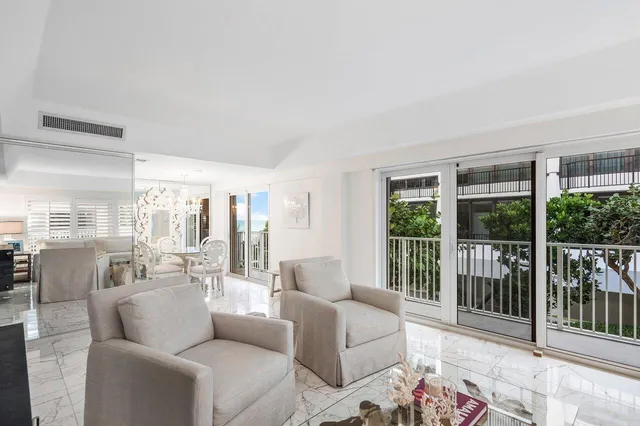 a living room with furniture and large windows
