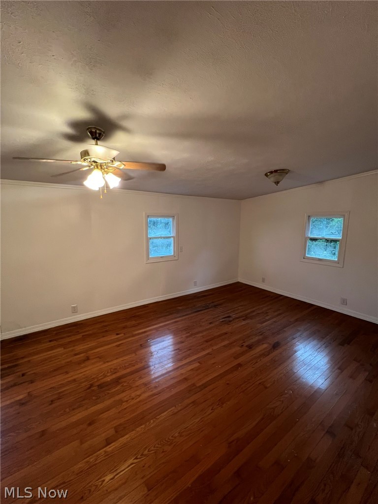 1105 Dutch Ridge Road Guysville, OH 45735 - Photo 13 of 33 Spacious room featuring rich wood-finish flooring, light-toned walls, and two windows providing natural illumination