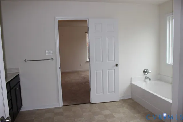 a bathroom with a tub and sink