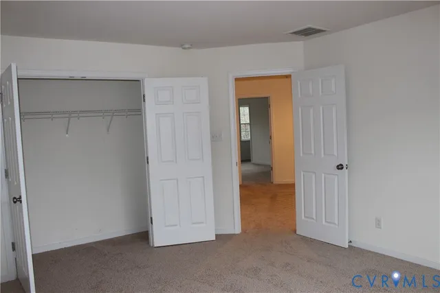 an empty room with closet area