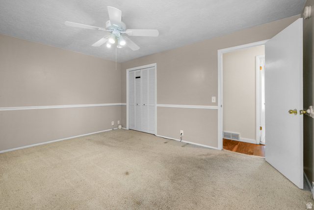 2088 Falcon Way Sandy, UT 84093 - Photo 25 of 46 Carpeted room featuring a ceiling fan with integrated lighting, bi-fold closet doors, wall molding, and a neutral color palette