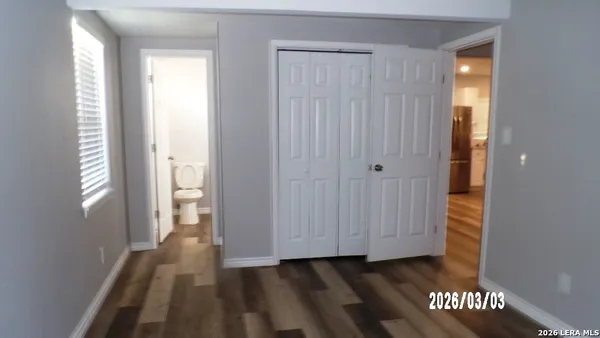 a bathroom with a toilet sink vanity and mirror