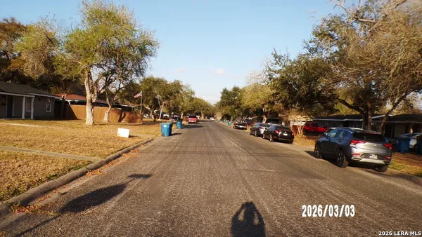 a view of street with parked cars