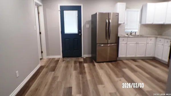 a kitchen with a refrigerator stove and white cabinets