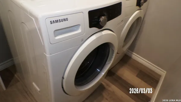 a white refrigerator freezer and a stove sitting inside of a room