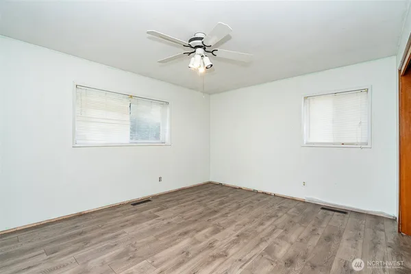 a view of an empty room with wooden floor