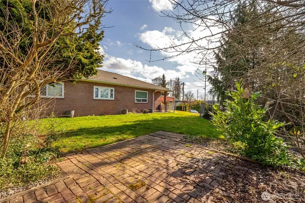 a view of a brick house with a yard