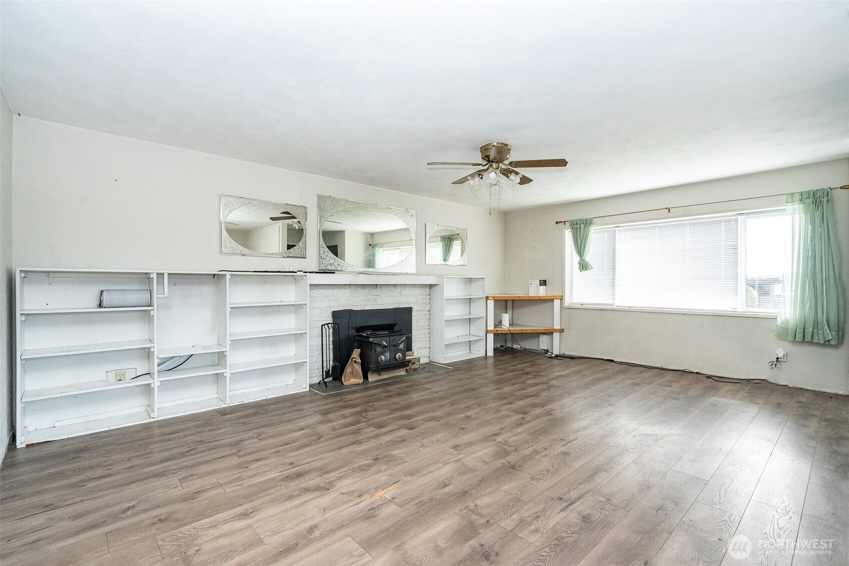 1428 Southwest Grandview Avenue Chehalis, WA 98532 - Photo 6 of 40 a view of an empty room with a fireplace and a window