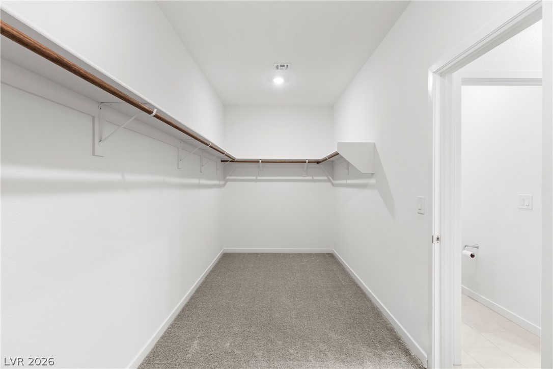 320 Isla Enclave Way Henderson, NV 89011 - Photo 17 of 49 An ample walk-in closet provides practical storage solutions with extensive shelving and hanging space.