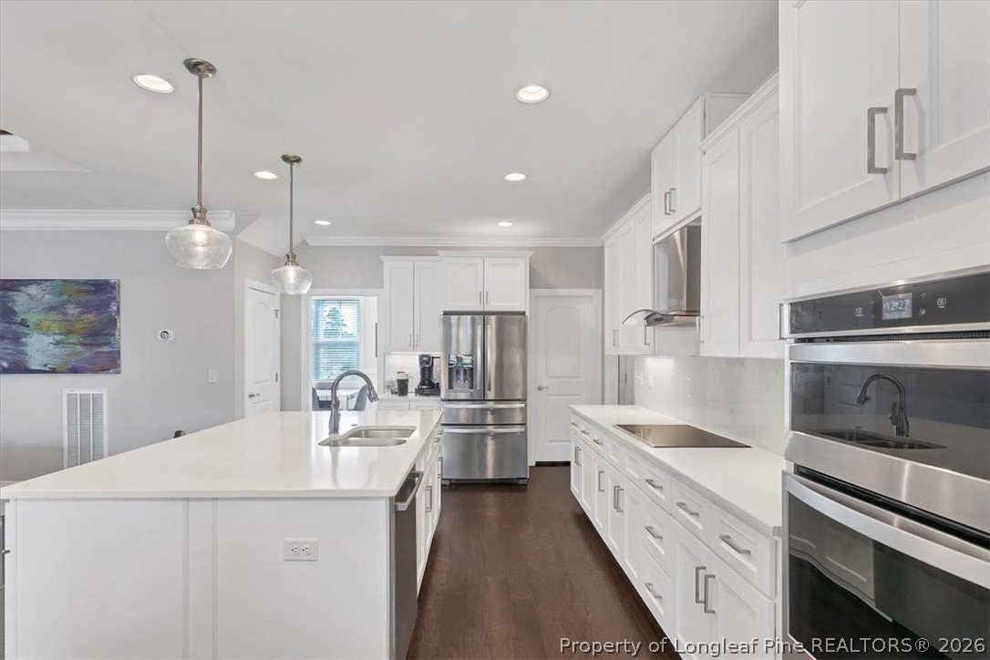 10 Heatherspring Way Spring Lake, NC 28390 - Photo 20 of 48 a kitchen with stainless steel appliances kitchen island granite countertop a sink and a refrigerator