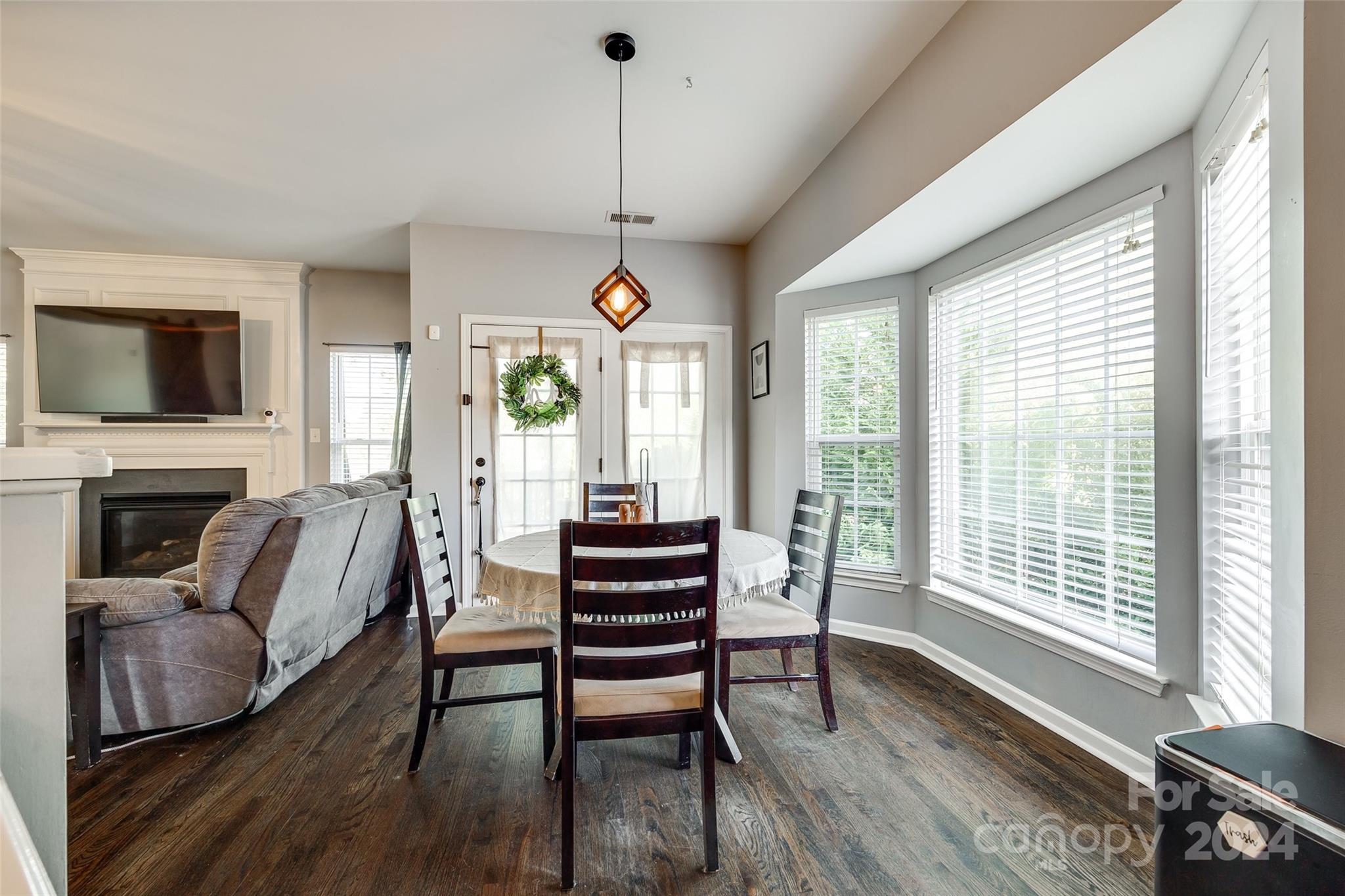 11417 Winget Pond Road Charlotte, NC 28278 - Photo 11 of 39 a living room with furniture a flat screen tv and a floor to ceiling window