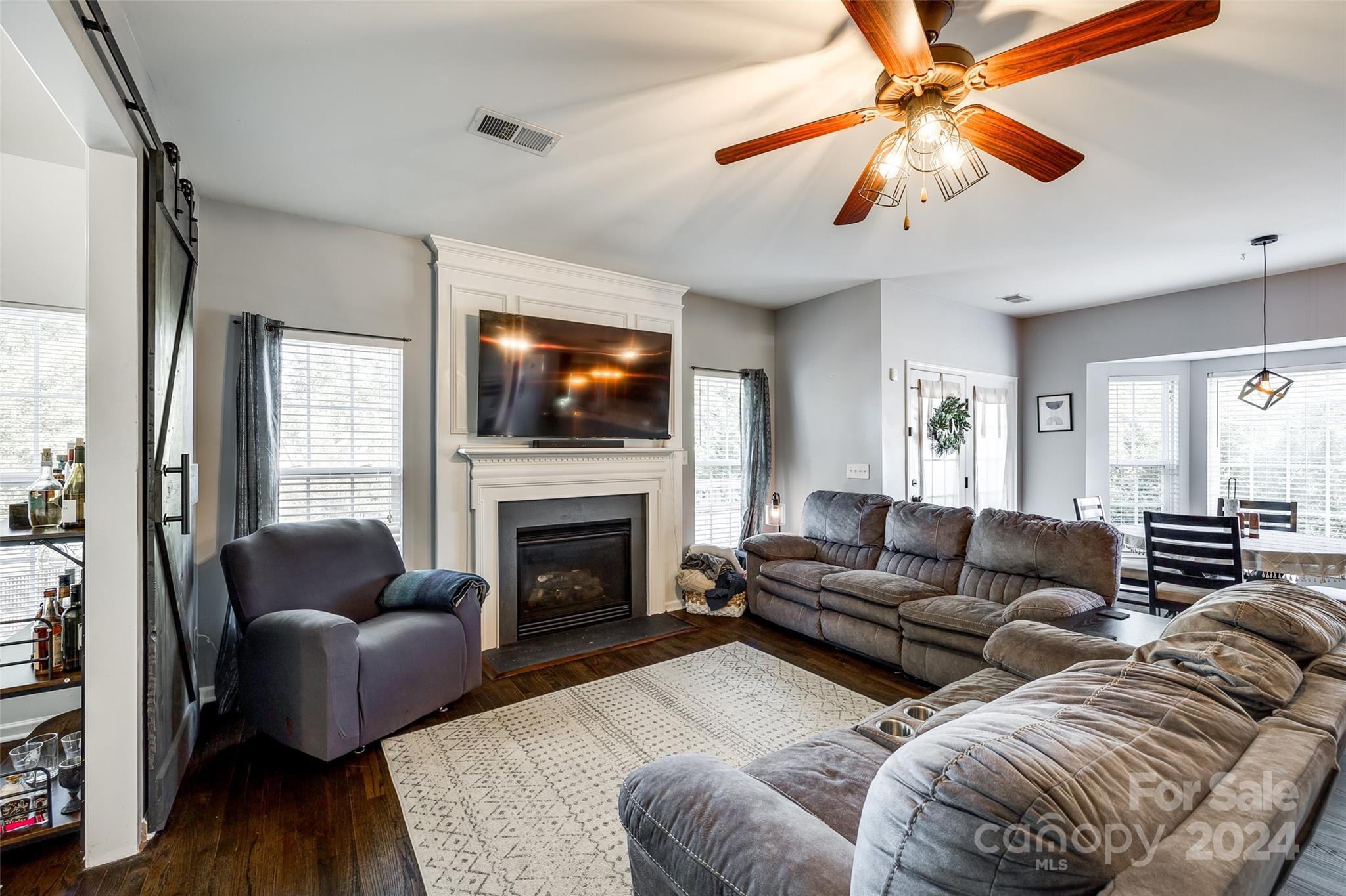 11417 Winget Pond Road Charlotte, NC 28278 - Photo 14 of 39 a living room with furniture a flat screen tv and a fireplace