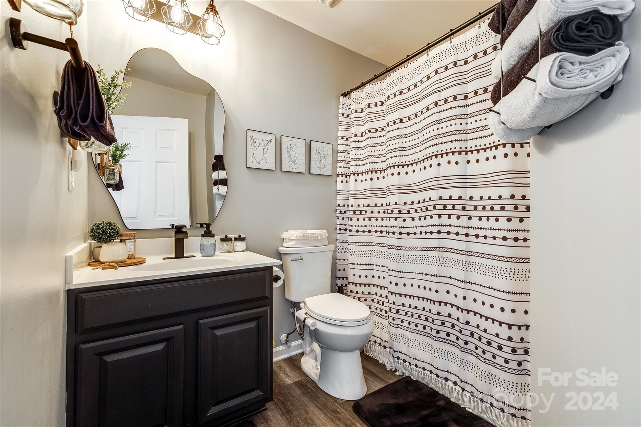 11417 Winget Pond Road Charlotte, NC 28278 - Photo 23 of 39 a bathroom with a sink a toilet and mirror