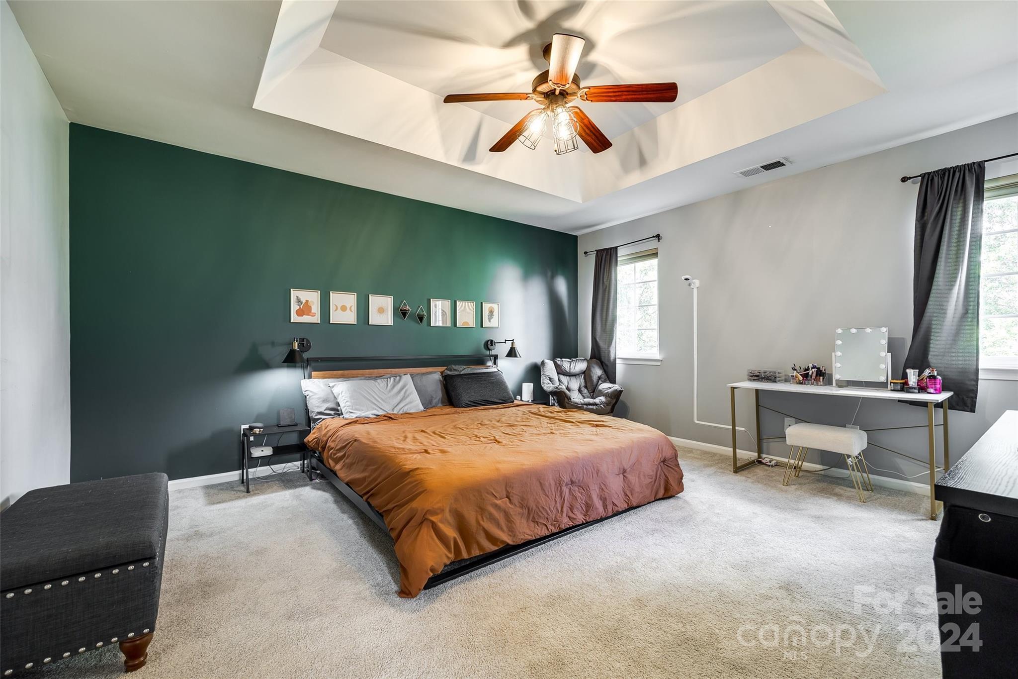 11417 Winget Pond Road Charlotte, NC 28278 - Photo 24 of 39 a bedroom with a bed and a chandelier