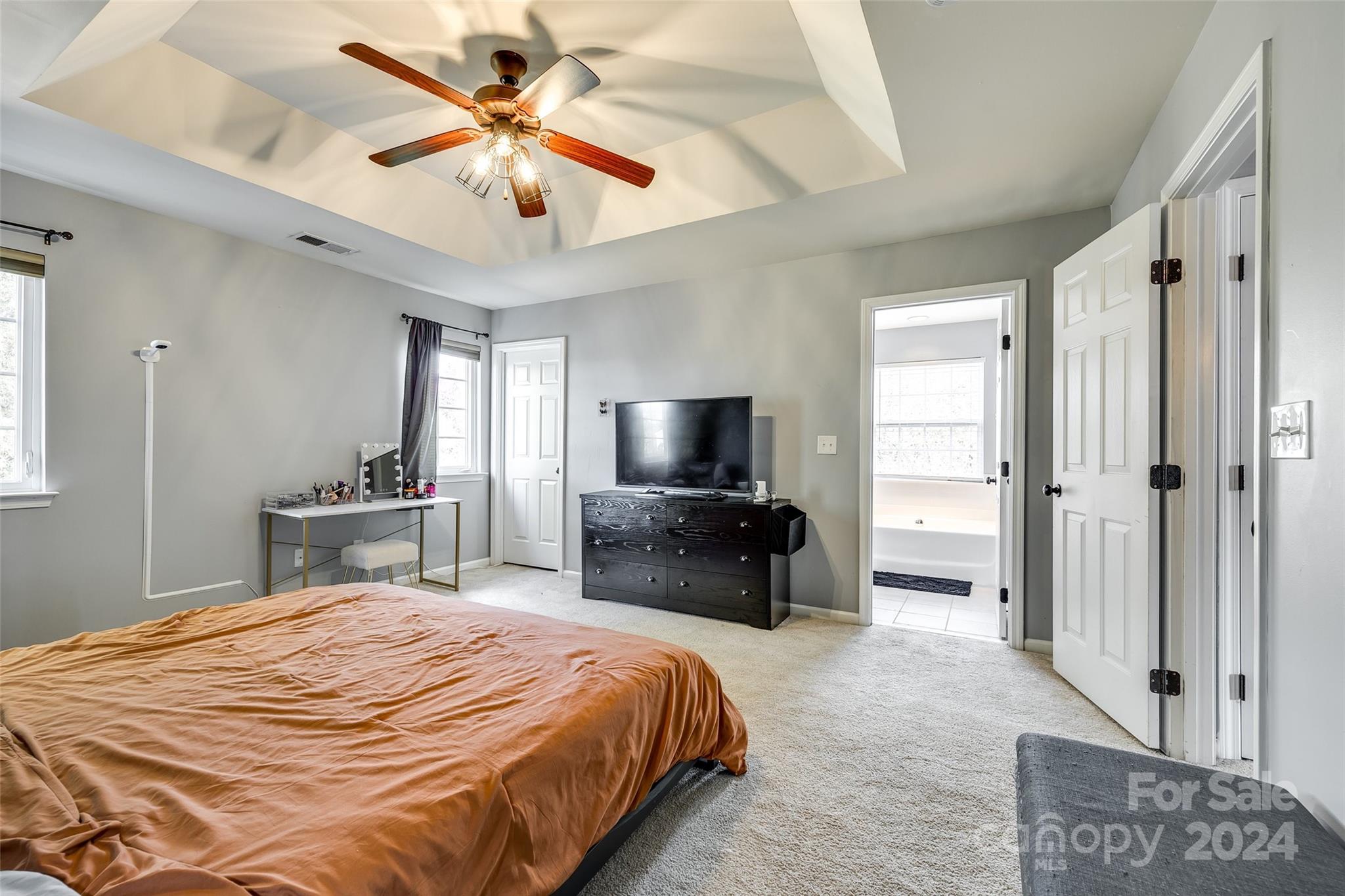 11417 Winget Pond Road Charlotte, NC 28278 - Photo 25 of 39 a bedroom with a bed and a chandelier