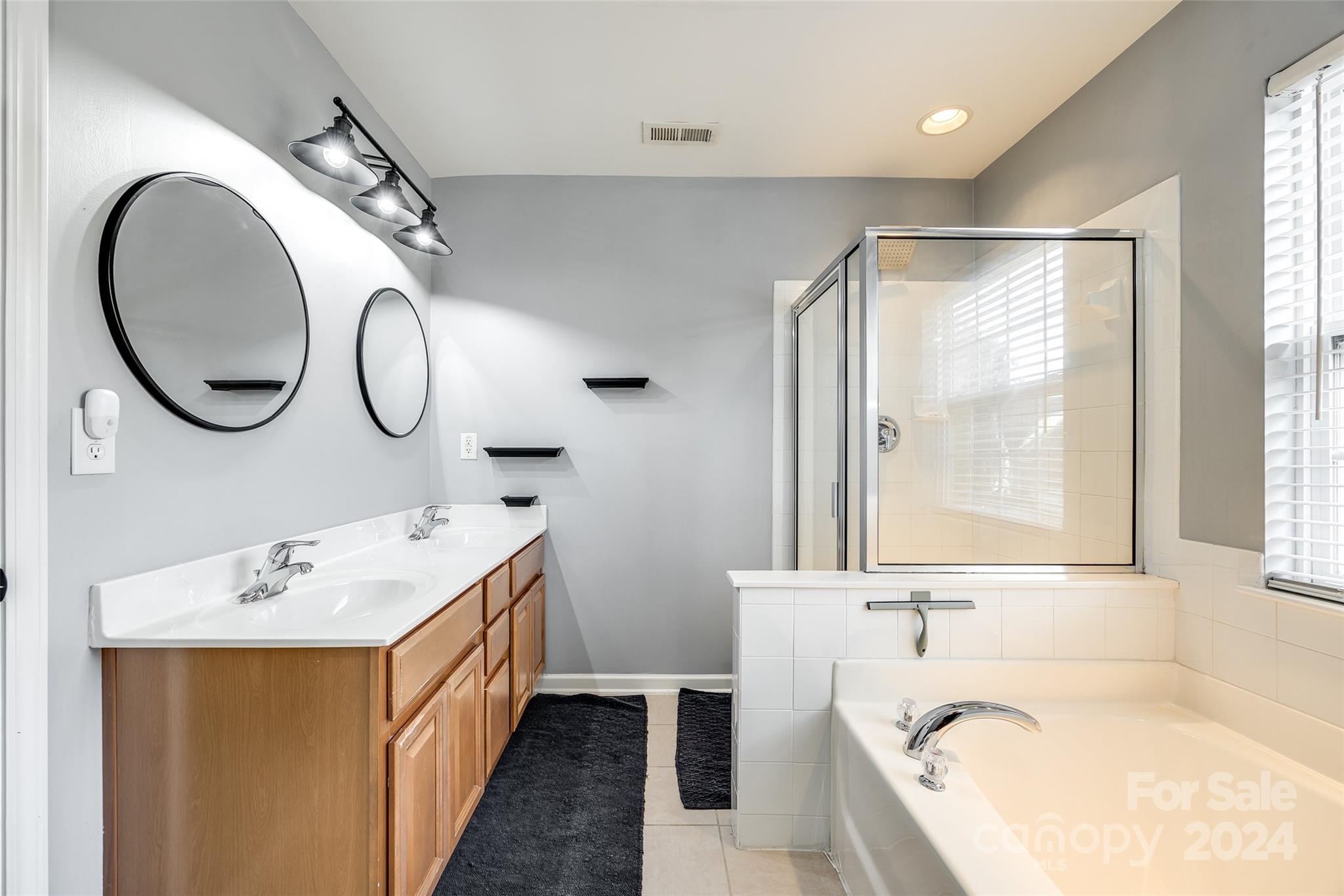 11417 Winget Pond Road Charlotte, NC 28278 - Photo 26 of 39 a bathroom with a tub sink and mirror