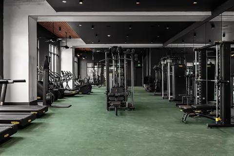 a room with gym equipment and a gym machine