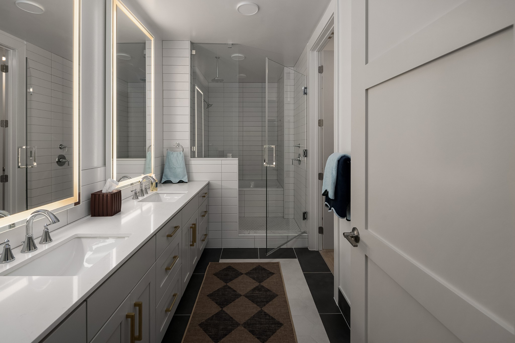 930 Commerce Street, Unit 28 Nashville, TN 37203 - Photo 6 of 31 a bathroom with a double vanity sink a mirror and shower