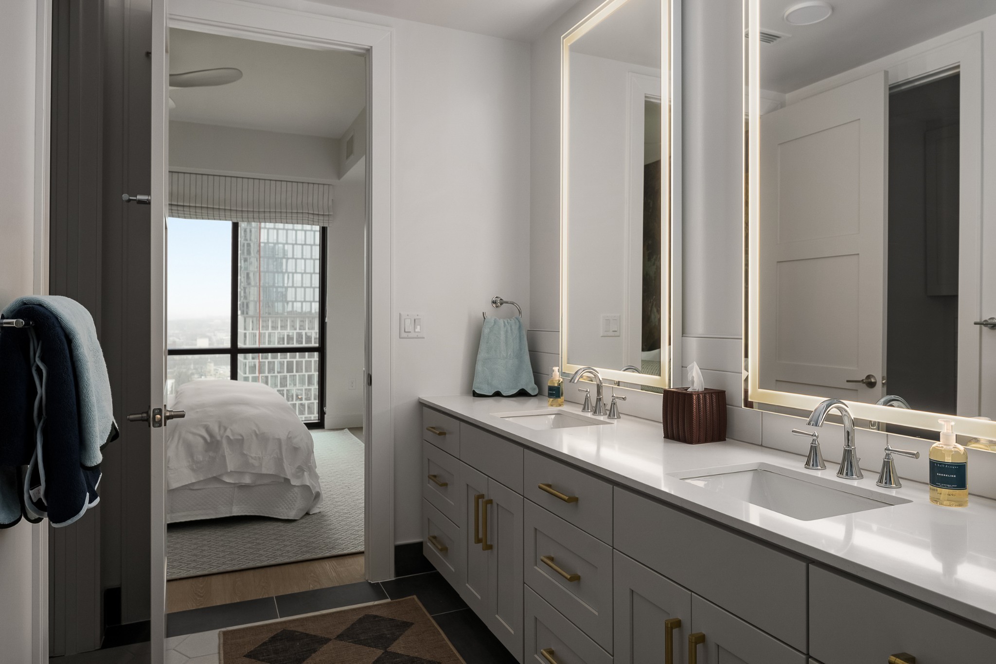 930 Commerce Street, Unit 28 Nashville, TN 37203 - Photo 7 of 31 a en suite bathroom with a double vanity sink and mirror