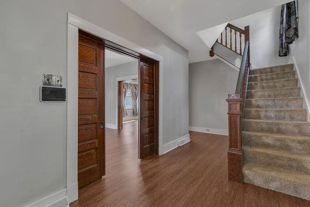 370 Ohio Avenue Rochester, PA 15074 - Photo 5 of 31 Foyer entry to stairs and living room with original pocket doors