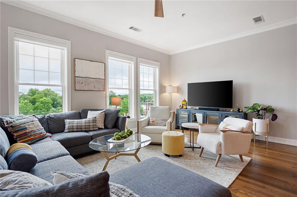 360 Chambers Street, Unit 407 Woodstock, GA 30188 - Photo 15 of 62 a living room with furniture and a flat screen tv