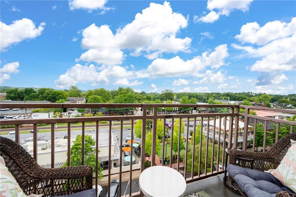360 Chambers Street, Unit 407 Woodstock, GA 30188 - Photo 22 of 62 a view of a balcony with lake view and a potted plant